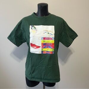 Green Graphic T-Shirt with Colorful Face Design